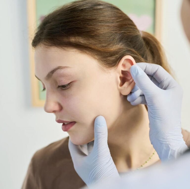 Auricular acupuncture treatment on a patient’s ear to support pain relief and health at Family Acupuncture Clinic Jacksonville.